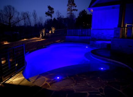Freeform Infinity Pool at night with blue lights