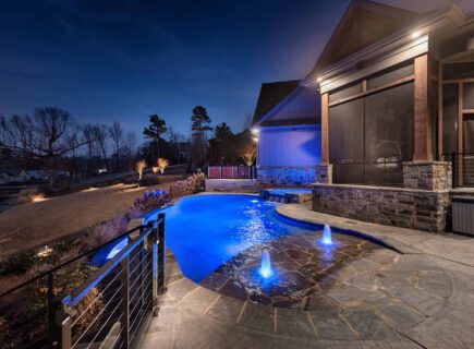 House with swimming pool at night in huntsville