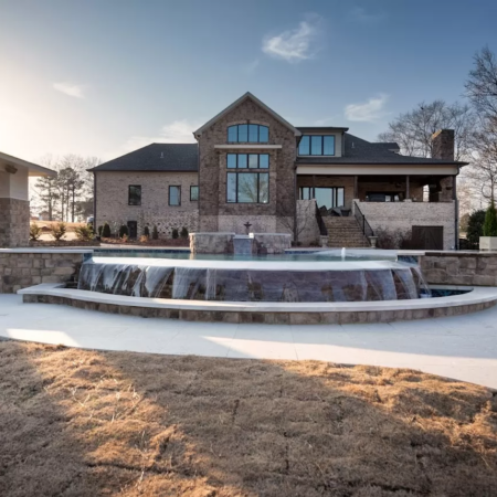 a pool with infinity pool next to a modern home