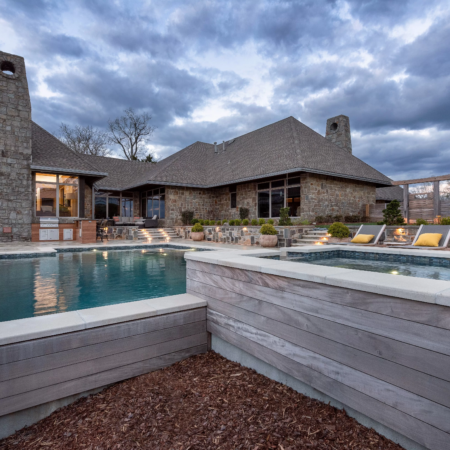 concrete luxury pool with infinity ledge