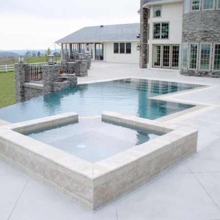 a square spa attached to an infinity pool