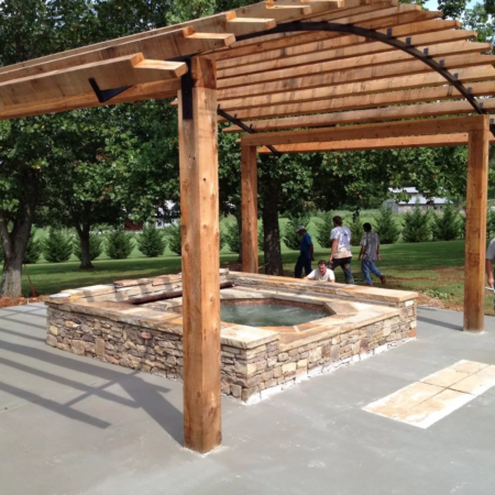 a single spa underneath a wooden canopy