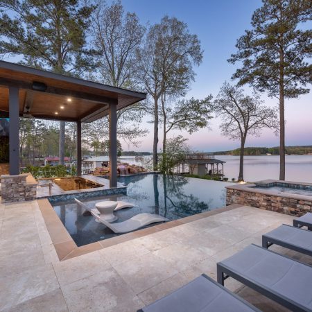 an infinity pool with built in spa and outdoor areas