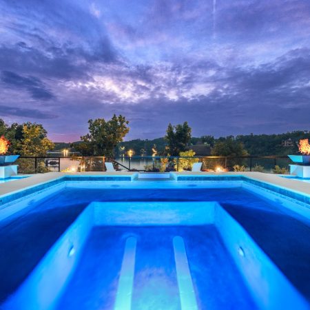 a geometric pool at dusk with pool lighting
