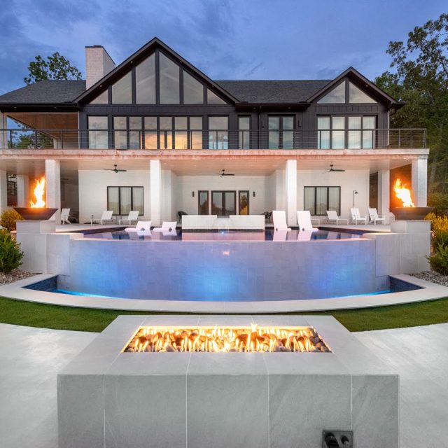 a raised luxury swimming pool with fire pits
