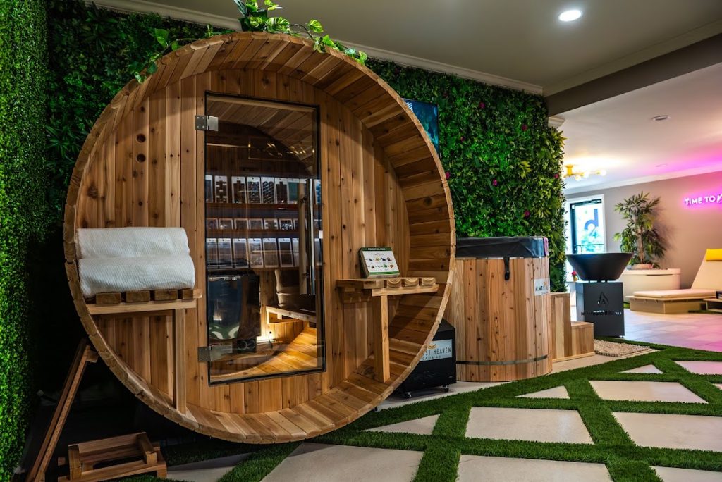 Luxury indoor sauna display at Burleson Master Pools Design Center featuring cedar barrel sauna and spa accessories